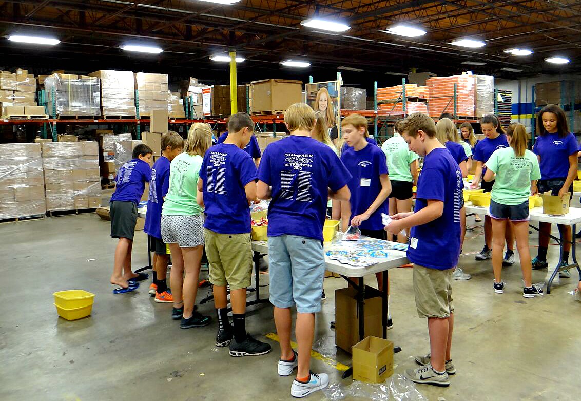 Youth from the Lord of Life Church in Blaine package MatterBoxes in the warehouse for children across the Twin Cities facing food insecurity this summer.