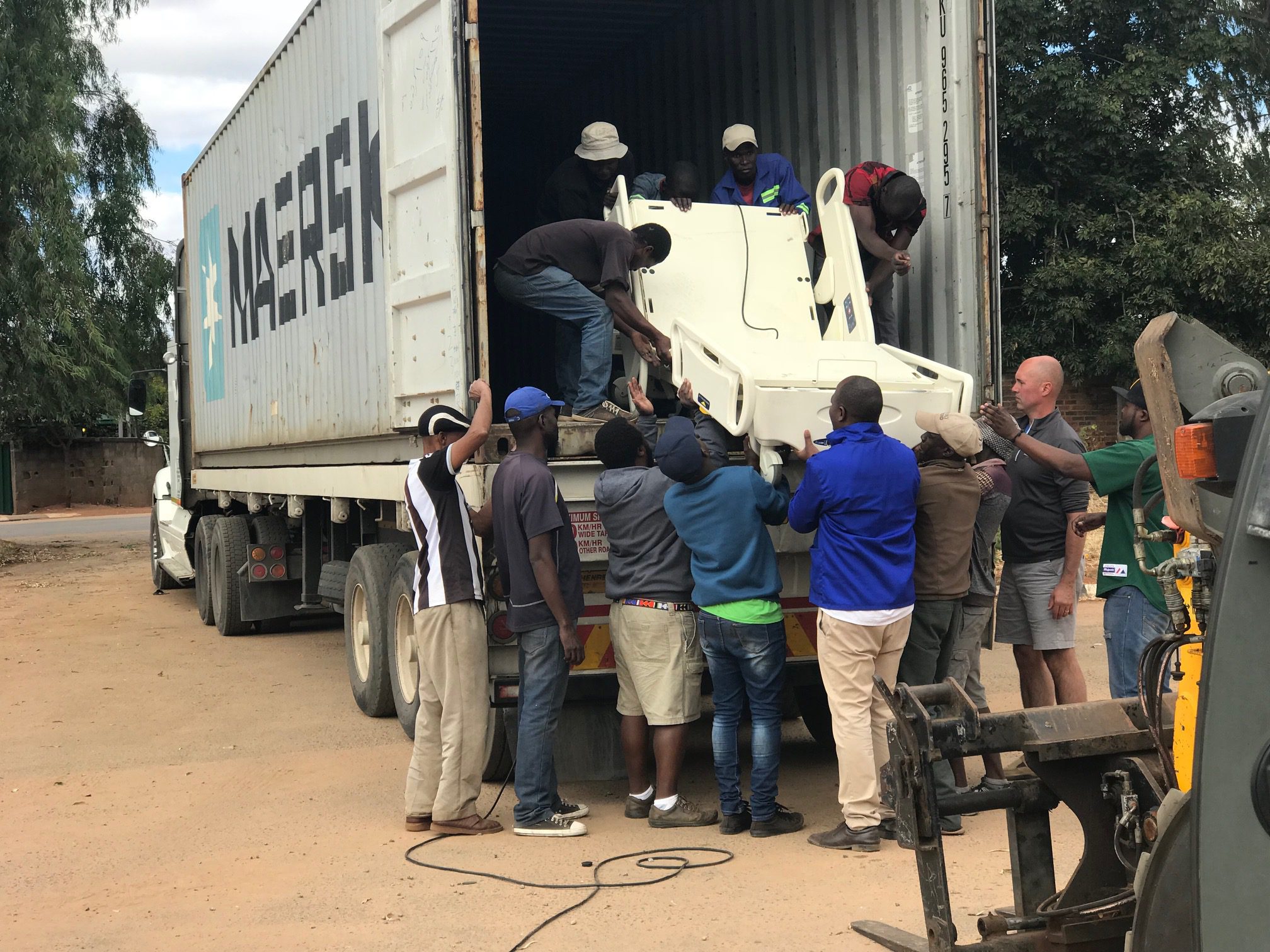 MATTER team unloading hospital equipment in Zimbabwe